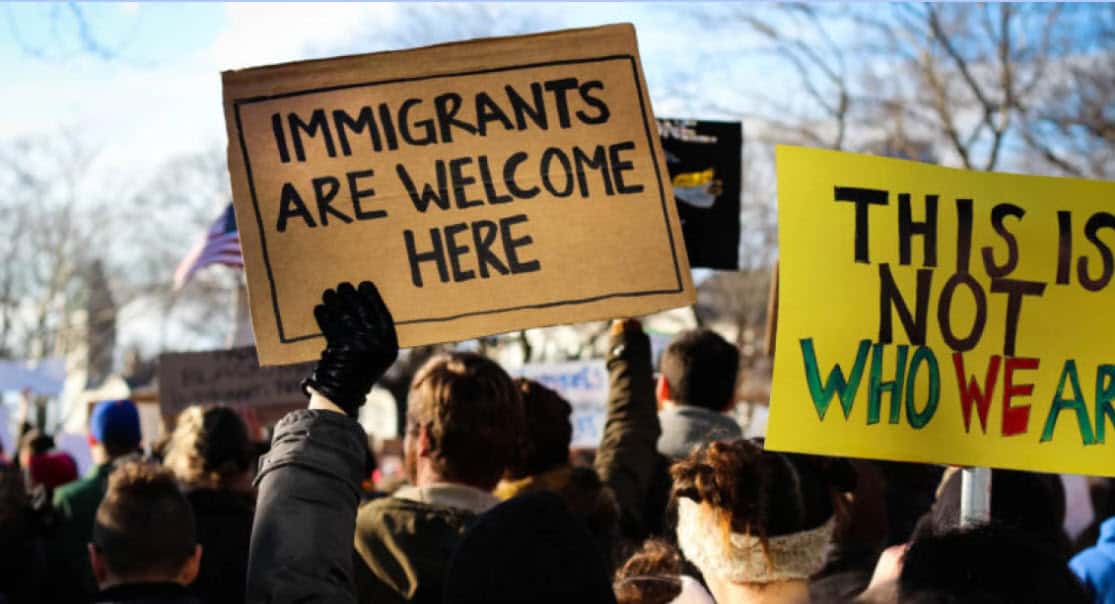 Rally with signs welcoming immigrants